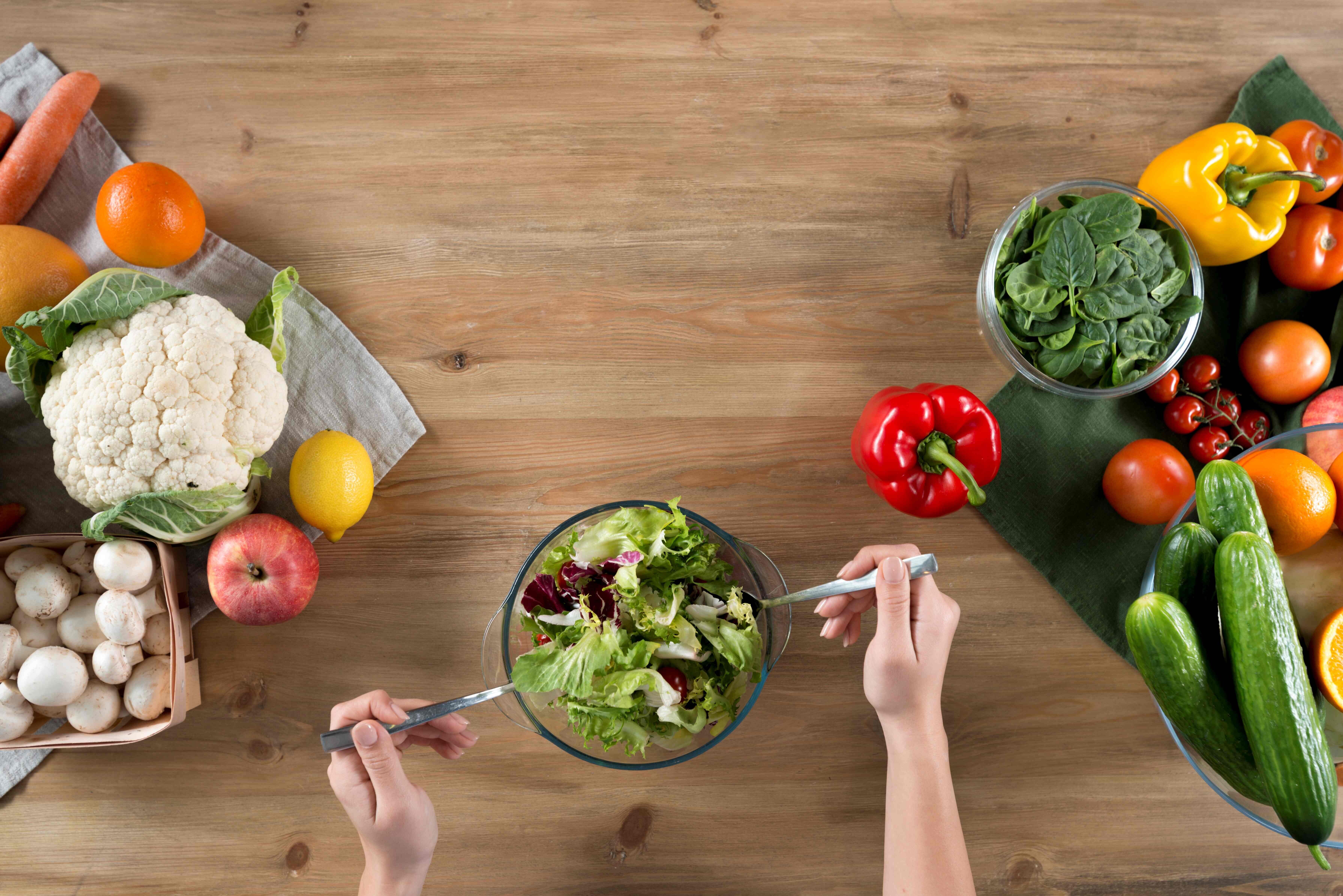 person-s-hand-preparing-fresh-healthy-salad-near-variety-vegetables-fruits-wooden-kitchen-counter DDDDDDDDDDDDDDDDDDDDDD.jpg